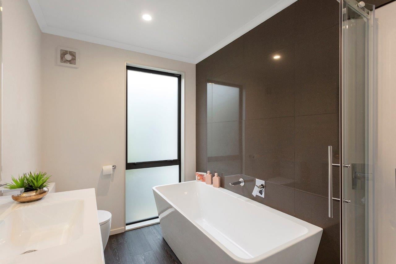 Black Thistle Construction minimalistic and practical bathroom layout 
with free standing bath for modern family life